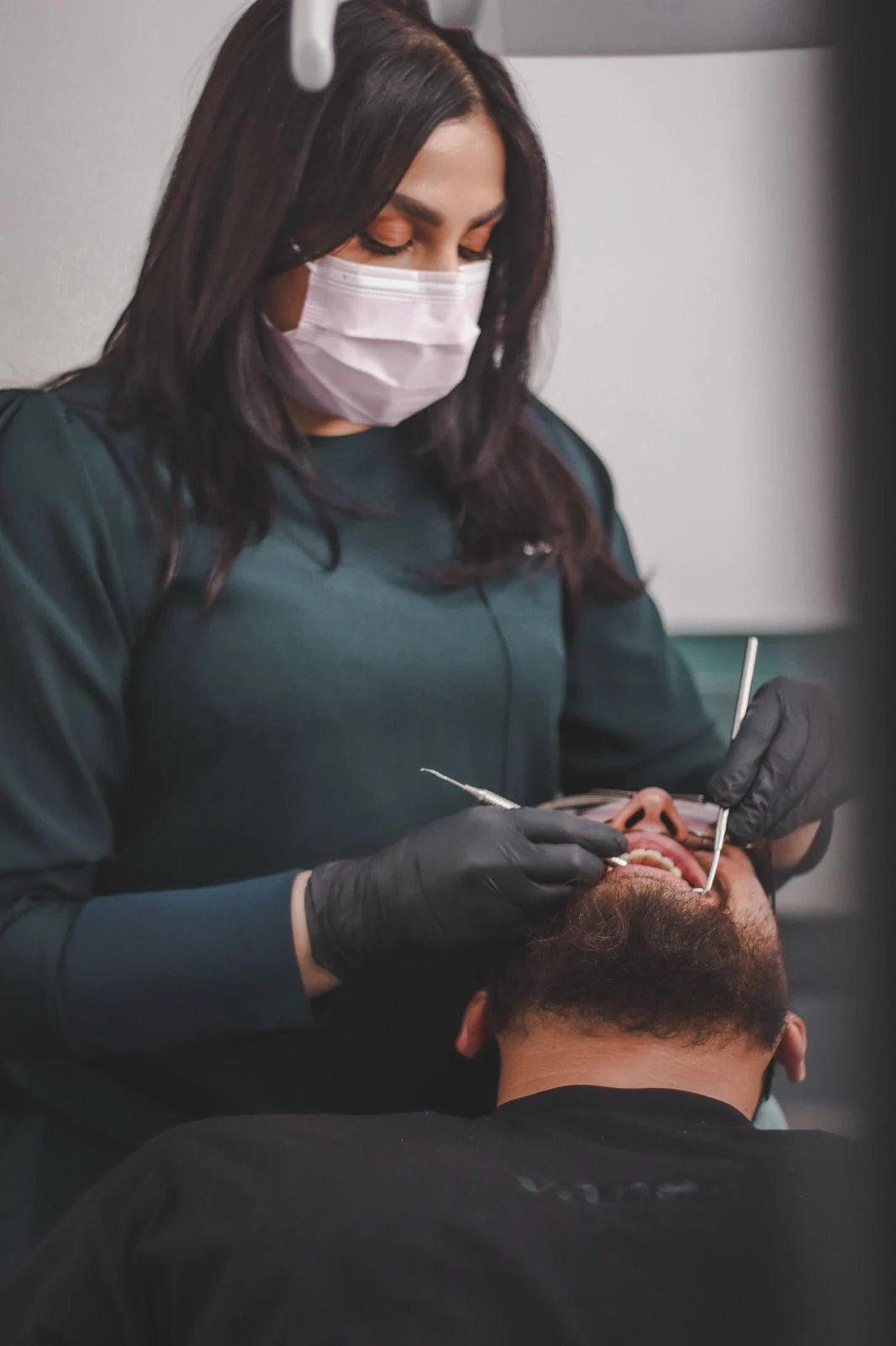 Dr Firdaus providing facial aesthetic care at the practice